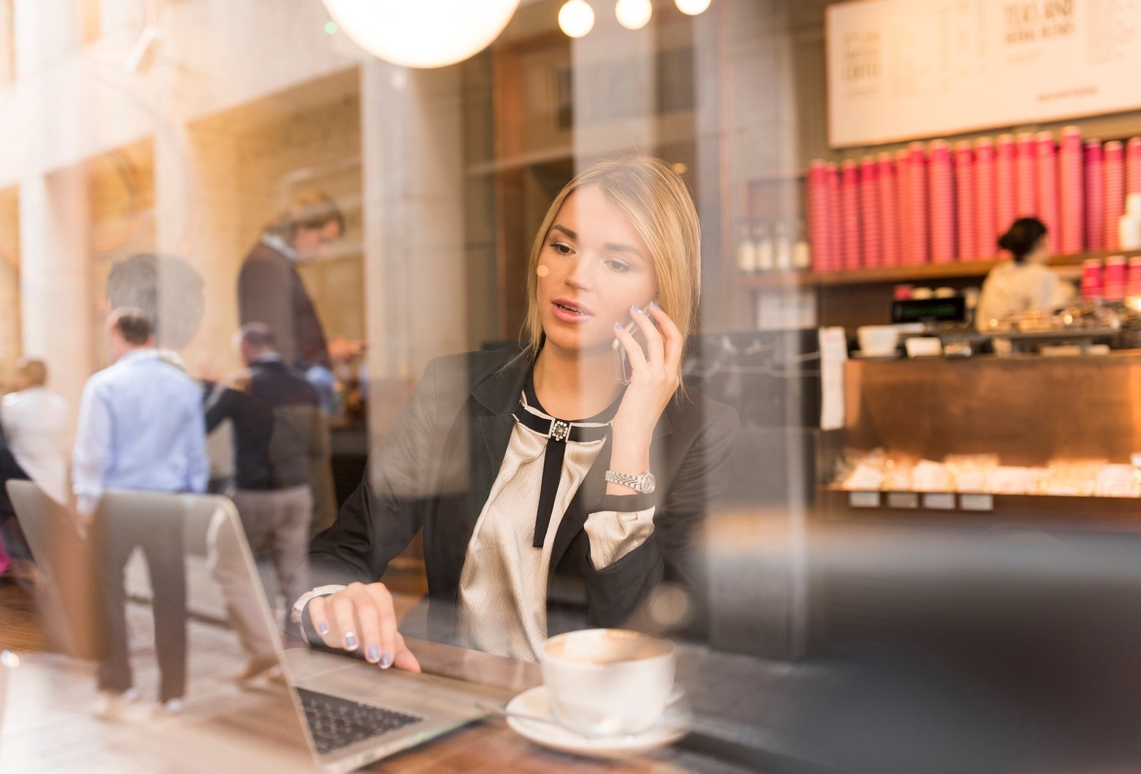 Businesswoman working on laptop in cafe