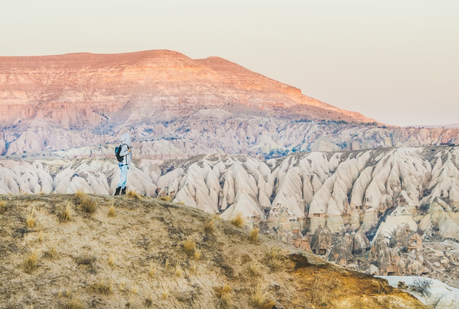 Young woman traveller hiking in mountains in Cappadocia, Turkey